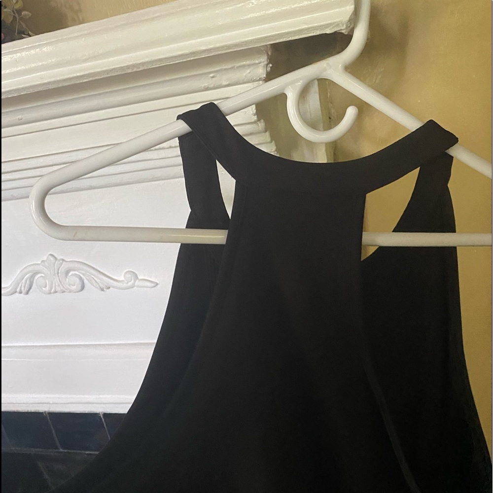 Black knit dress with racer back and cute details. Gently worn a time or two.